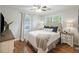 Serene bedroom featuring hardwood floors, a queen-sized bed, and natural light from the windows at 825 Savage Rd, Charleston, SC 29414