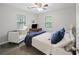 Bright bedroom boasts multiple windows, a cozy chair, and a plush bed with blue accents at 825 Savage Rd, Charleston, SC 29414