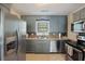 Stylish kitchen featuring stainless steel appliances, wood countertops, and modern blue cabinets at 825 Savage Rd, Charleston, SC 29414