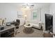 Cozy living room includes a sofa, desk, television, and a ceiling fan at 825 Savage Rd, Charleston, SC 29414