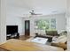 Inviting living room featuring hardwood floors, large windows, and a comfortable sectional sofa at 825 Savage Rd, Charleston, SC 29414