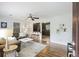 Bright living room featuring hardwood floors, neutral walls, ceiling fan, and an open view to the kitchen at 825 Savage Rd, Charleston, SC 29414