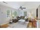 Cozy living room with hardwood floors, a large window, comfortable seating, and a ceiling fan at 825 Savage Rd, Charleston, SC 29414