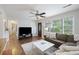 Bright living room with hardwood floors, a ceiling fan, and a large window offering plenty of natural light at 825 Savage Rd, Charleston, SC 29414