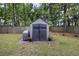 Outdoor storage shed with flower pots and a BBQ grill, with neutral gray paint at 825 Savage Rd, Charleston, SC 29414