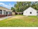 Spacious backyard featuring lush lawn and a detached garage with carport at 8612 Delhi Rd, North Charleston, SC 29406