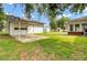 Backyard featuring a detached garage, carport, storage shed, and play equipment at 8612 Delhi Rd, North Charleston, SC 29406