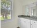 Bathroom featuring granite countertop, modern fixtures, and a bright window at 8612 Delhi Rd, North Charleston, SC 29406