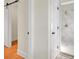 Bathroom featuring a sliding barn door and a modern shower with marble-look tile at 8612 Delhi Rd, North Charleston, SC 29406