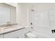 Bright bathroom features a granite countertop, white vanity, and tub with shower at 8612 Delhi Rd, North Charleston, SC 29406