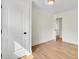 This bedroom has hardwood floors, white trim, and an open doorway at 8612 Delhi Rd, North Charleston, SC 29406