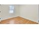 Cozy bedroom featuring natural light from a large window and hardwood floors at 8612 Delhi Rd, North Charleston, SC 29406