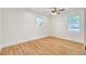 Bright bedroom with hardwood floors, a ceiling fan, and natural light from two windows at 8612 Delhi Rd, North Charleston, SC 29406