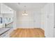 Open dining area with modern lighting, hardwood floors, and white trim at 8612 Delhi Rd, North Charleston, SC 29406
