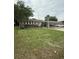 Traditional brick home featuring a well-manicured lawn and convenient covered parking at 8612 Delhi Rd, North Charleston, SC 29406