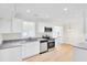 Bright kitchen featuring white cabinets, granite counters, and stainless appliances at 8612 Delhi Rd, North Charleston, SC 29406