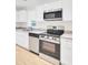 Bright kitchen featuring white cabinets, granite counters, and stainless appliances at 8612 Delhi Rd, North Charleston, SC 29406