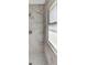 Modern shower with gray-veined marble wall tiles and a window at 8612 Delhi Rd, North Charleston, SC 29406
