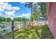 Backyard with a white picket fence and partial view of a pond at 8965 N Red Maple Cir, Summerville, SC 29485