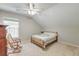 Bedroom with an angled ceiling and a window with natural light, offering a cozy atmosphere at 8965 N Red Maple Cir, Summerville, SC 29485