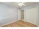 Light and airy bedroom featuring hardwood floors, neutral walls, a ceiling fan, and closet at 8965 N Red Maple Cir, Summerville, SC 29485