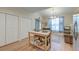 Bright dining area featuring a table with seating, sliding glass door and white closets at 8965 N Red Maple Cir, Summerville, SC 29485