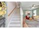 Light-filled foyer featuring a staircase, hardwood floors, and open view to the living room at 8965 N Red Maple Cir, Summerville, SC 29485