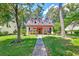 Charming curb appeal featuring a red two-story home with a well-manicured lawn and mature trees at 8965 N Red Maple Cir, Summerville, SC 29485
