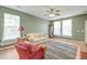 Cozy living room with light green walls, wood floors, and a colorful area rug at 8965 N Red Maple Cir, Summerville, SC 29485