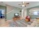 Cozy living room with hardwood floors, ceiling fan, and view to the kitchen and entryway at 8965 N Red Maple Cir, Summerville, SC 29485