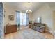 Bright living room showcasing hardwood floors, a chandelier, and a comfortable seating area at 8965 N Red Maple Cir, Summerville, SC 29485