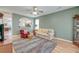Inviting living room with a ceiling fan, archway view to kitchen, and a patterned rug at 8965 N Red Maple Cir, Summerville, SC 29485
