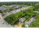 Aerial shot of property outlined in yellow with surrounding greenery and neighborhood commercial properties at 9 Wesley Dr, Charleston, SC 29407