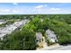Aerial view showcasing the house among lush greenery in a residential area, street access and neighborhood at 9 Wesley Dr, Charleston, SC 29407