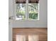 Charming bedroom with hardwood floors, a vintage doorknob, and a view to lush outdoors at 9 Wesley Dr, Charleston, SC 29407
