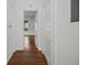 Hallway with wooden floors and white doors offer a bright and clean aesthetic at 9 Wesley Dr, Charleston, SC 29407