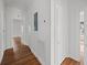 Hallway with hardwood floors leads to various rooms, showcasing classic doors and hardware at 9 Wesley Dr, Charleston, SC 29407