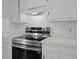 Close-up showcasing a stainless steel range and hood, complemented by white countertops and cabinets at 9 Wesley Dr, Charleston, SC 29407