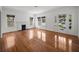 Spacious living room with gleaming hardwood floors, a cozy fireplace, and large windows at 9 Wesley Dr, Charleston, SC 29407