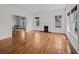 Bright living room featuring hardwood floors, a brick fireplace, and ample natural light at 9 Wesley Dr, Charleston, SC 29407