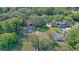 Expansive aerial view featuring a pool, outdoor firepit, and the surrounding leafy neighborhood at 932 N Shem Dr, Mount Pleasant, SC 29464