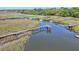 Aerial view of waterfront property featuring private docks, boardwalks, and serene marshland, offering a tranquil setting at 932 N Shem Dr, Mount Pleasant, SC 29464