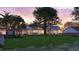 Expansive backyard with lush green grass surrounding a beautiful home with a metal roof and stone accents at 932 N Shem Dr, Mount Pleasant, SC 29464