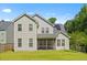 The back exterior of this two-story home features solar panels, a screened-in porch, and a well-manicured lawn at 101 Caleb Ct, Ladson, SC 29456