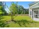 Green backyard features a well-maintained lawn, mature trees, and a privacy fence at 101 Caleb Ct, Ladson, SC 29456