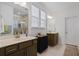 Bright bathroom featuring a double sink vanity, white countertops, and a glass enclosed shower at 101 Caleb Ct, Ladson, SC 29456