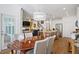 Open dining room and kitchen with fireplace, dining table with chairs, island and stainless appliances at 101 Caleb Ct, Ladson, SC 29456