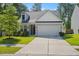 Charming home with well-manicured lawn, mature trees, gray siding, and an attached two-car garage at 101 Caleb Ct, Ladson, SC 29456