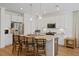Bright, white kitchen features an island with barstool seating, stainless appliances, and ample counter space at 101 Caleb Ct, Ladson, SC 29456