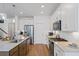 Spacious kitchen features stainless steel appliances, white subway tile backsplash, and an island at 101 Caleb Ct, Ladson, SC 29456